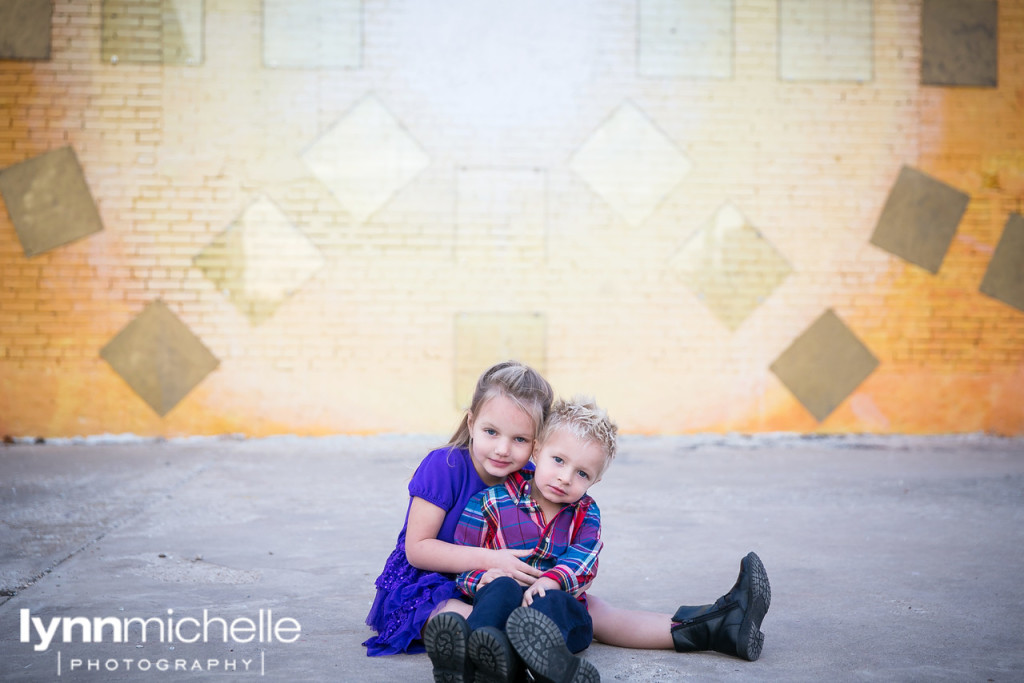colorful family portraits at rainbow wall in dallas